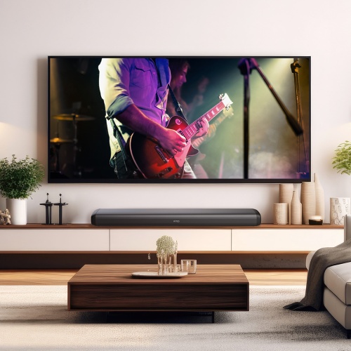 Elegantná obývacia izba s obrazom gitaristu na TV a soundbarom TESLA PrimeSound HQ-990 umiestneným pod ním.